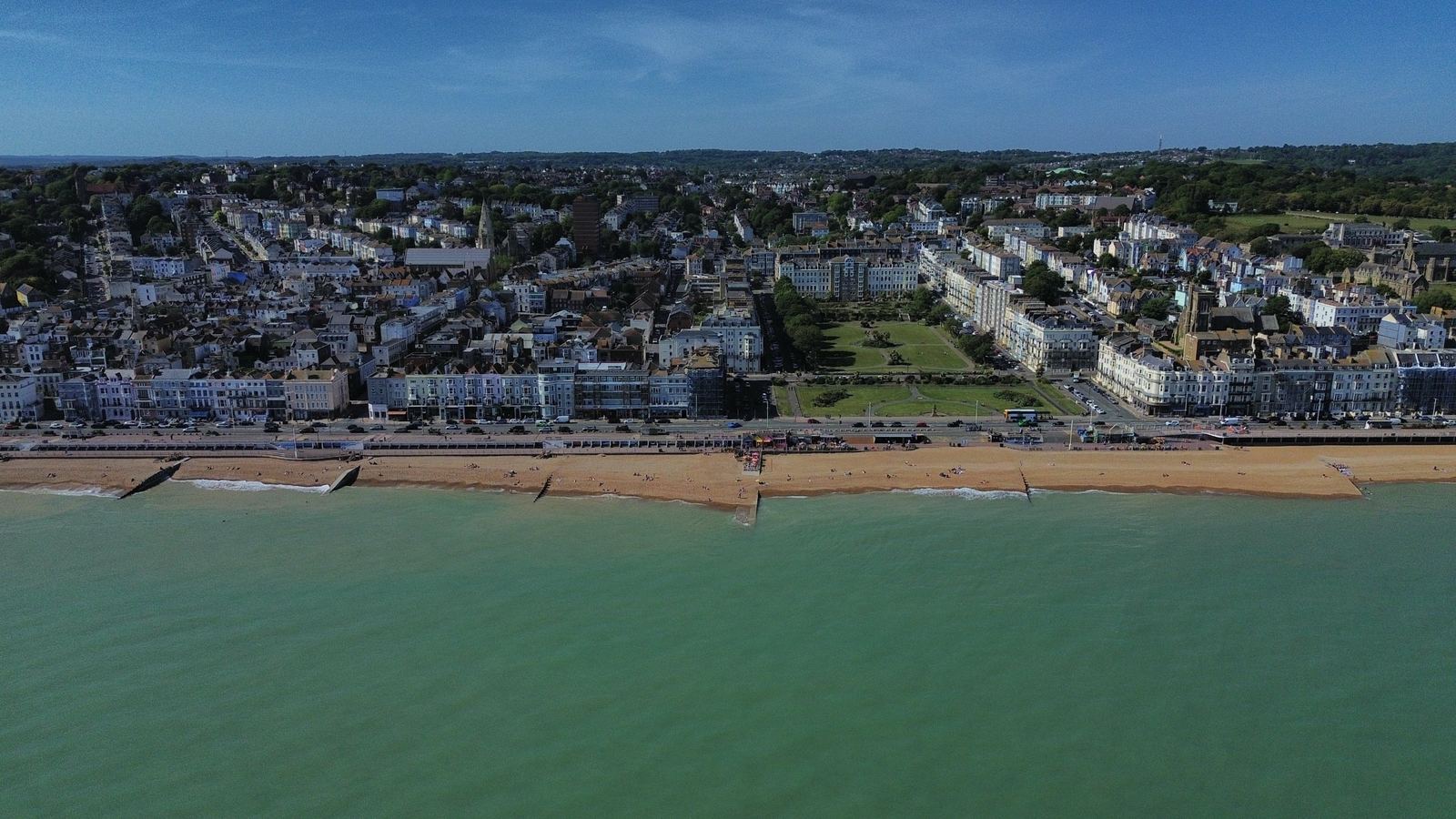Aerial drone photo of the St Leonards-on-Sea seafront in East Sussex, with the beach, promenade, seafront gardens and rows of seafront buildings
